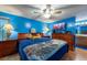 Bright bedroom with a ceiling fan, wooden furniture, and a view to the bathroom at 3509 King George Ln, Seffner, FL 33584