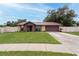 Inviting single-Gathering home with a lush lawn, updated driveway, and charming front entrance at 3509 King George Ln, Seffner, FL 33584