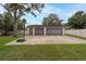 Detached two-car garage with a spacious driveway and basketball hoop in a large backyard, perfect for recreation at 3509 King George Ln, Seffner, FL 33584