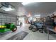 A spacious garage interior with riding lawn mower and garage door, offering convenient access and ample storage at 3509 King George Ln, Seffner, FL 33584