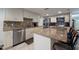 Bright kitchen featuring stainless steel appliances, granite countertops, and island with seating at 3509 King George Ln, Seffner, FL 33584
