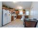 Bright kitchen with white appliances, oak cabinetry, and tile floors at 3509 King George Ln, Seffner, FL 33584