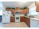 Well-lit kitchen featuring white appliances and plenty of cabinet space at 3509 King George Ln, Seffner, FL 33584
