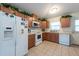 Functional kitchen with white appliances, tiled floor, and ample cabinetry at 3509 King George Ln, Seffner, FL 33584