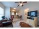 Open-concept living room with tile floors, and a large TV at 3509 King George Ln, Seffner, FL 33584