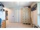Office featuring shelves, lockers, a closet, fan, and a glimpse into the bathroom at 3509 King George Ln, Seffner, FL 33584
