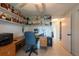 Office features shelves, desk, fan, printer, and glimpses into the hallway and bathroom at 3509 King George Ln, Seffner, FL 33584