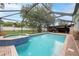 Screened pool and spa with brick patio, leading to the backyard at 3509 King George Ln, Seffner, FL 33584