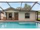 Rear exterior showing a screened pool with attached seating area at 3509 King George Ln, Seffner, FL 33584