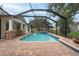 Screened-in pool with attached spa, surrounded by brick paving and lush greenery at 3509 King George Ln, Seffner, FL 33584