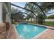Backyard pool and spa with brick patio and screen enclosure, offering privacy and shade at 3509 King George Ln, Seffner, FL 33584