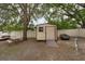Backyard shed with a picnic table, offering ample storage and recreational space, set against a fenced perimeter at 3509 King George Ln, Seffner, FL 33584