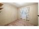Comfortable carpeted bedroom with wood paneled walls and a window at 36701 Jodi Ave, Zephyrhills, FL 33542