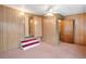 Neutral bedroom featuring wood paneled walls with an entrance to another room at 36701 Jodi Ave, Zephyrhills, FL 33542