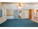 Open living room with ceiling fan, neutral walls, and blue carpeting at 36701 Jodi Ave, Zephyrhills, FL 33542