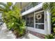 Charming entrance with screen door, awning, and lush tropical landscaping provides a welcoming feel to this beautiful condo at 4154 56Th N St # 720, Kenneth City, FL 33709