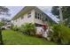 Exterior elevation of the condo building, showcasing well-maintained landscaping at 4154 56Th N St # 720, Kenneth City, FL 33709