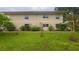 Exterior shot of building, highlighting the lawn and surrounding greenery at 4154 56Th N St # 720, Kenneth City, FL 33709