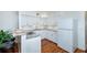 Modern kitchen with white cabinets, stainless steel appliances, granite countertops, and wood flooring at 4154 56Th N St # 720, Kenneth City, FL 33709