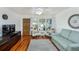Cozy living room showcasing wood floors, stylish seating, and natural light from a large window at 4154 56Th N St # 720, Kenneth City, FL 33709