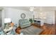 Open-concept living area showcasing wood floors, modern furniture, and seamless flow to the kitchen at 4154 56Th N St # 720, Kenneth City, FL 33709