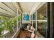 Charming screened porch with tile flooring, comfortable seating, and decorative wall art at 4154 56Th N St # 720, Kenneth City, FL 33709