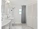 Well-lit bathroom with a double sink vanity and tiled walk-in shower with modern fixtures at 4309 W Empedrado St, Tampa, FL 33629