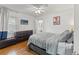 Comfortable bedroom with hardwood floors, a television, and ample natural light at 4309 W Empedrado St, Tampa, FL 33629