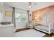 Cozy Bedroom with a white crib, soft rug, and an accent wall with a unique design at 4309 W Empedrado St, Tampa, FL 33629
