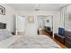 Comfortable bedroom with hardwood floors, a television, and a closet with mirrored doors at 4309 W Empedrado St, Tampa, FL 33629