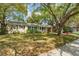 Inviting home with lush lawn and mature trees, offering shade and curb appeal at 4309 W Empedrado St, Tampa, FL 33629