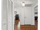 Bright hallway with hardwood floors leading to bedrooms, a closet, and a full bathroom at 4309 W Empedrado St, Tampa, FL 33629