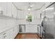 Bright kitchen featuring white cabinets, stainless steel appliances, marble countertops, and hardwood floors at 4309 W Empedrado St, Tampa, FL 33629
