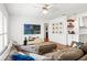 Cozy living room featuring a plush sectional sofa, a large television, and hardwood floors at 4309 W Empedrado St, Tampa, FL 33629