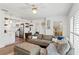 Bright and inviting living room with a large sectional sofa and hardwood floors at 4309 W Empedrado St, Tampa, FL 33629