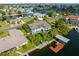An aerial view showcases a charming waterfront home with an expansive yard and private boat dock at 4523 Gulfstream Dr, Hernando Beach, FL 34607