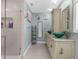A stylish bathroom boasts double sinks, granite countertops, and a walk-in shower at 4523 Gulfstream Dr, Hernando Beach, FL 34607