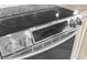 A close-up of a black ceramic cooktop with stainless steel knobs and a sleek design at 4523 Gulfstream Dr, Hernando Beach, FL 34607