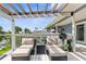 Relax on this outdoor deck featuring comfortable lounge chairs and a scenic view of the surrounding neighborhood and canal at 4523 Gulfstream Dr, Hernando Beach, FL 34607
