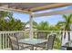 Outdoor deck featuring a dining area with comfortable seating and picturesque views of the surrounding nature at 4523 Gulfstream Dr, Hernando Beach, FL 34607