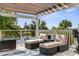 Relaxing outdoor deck with comfortable seating, perfect for enjoying the waterfront views and gentle breeze at 4523 Gulfstream Dr, Hernando Beach, FL 34607