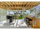 Outdoor entertainment area with bar, seating, and views of the lush landscaping and canal at 4523 Gulfstream Dr, Hernando Beach, FL 34607