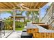Outdoor entertainment area with bar and gazebo overlooking the canal and mature landscaping at 4523 Gulfstream Dr, Hernando Beach, FL 34607