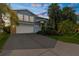 Two-story home featuring stone accents, an attached garage, and mature landscaping at 4523 Gulfstream Dr, Hernando Beach, FL 34607