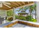 Inviting backyard gazebo featuring wood beams, outdoor seating, lush landscaping, and waterfront views at 4523 Gulfstream Dr, Hernando Beach, FL 34607