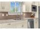 Well-appointed kitchen featuring stainless steel appliances, tile backsplash, and a modern sink at 4523 Gulfstream Dr, Hernando Beach, FL 34607