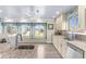 Bright kitchen featuring granite countertops, stainless steel appliances, and a window seat with water views at 4523 Gulfstream Dr, Hernando Beach, FL 34607