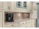 Kitchen area featuring custom cabinetry, decorative backsplash, granite countertops, and modern appliances at 4523 Gulfstream Dr, Hernando Beach, FL 34607