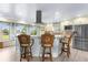 Kitchen island with bar seating, stainless appliances, and a custom range hood at 4523 Gulfstream Dr, Hernando Beach, FL 34607