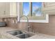 Close up on a well-appointed kitchen featuring granite countertops, tile backsplash, and a modern sink at 4523 Gulfstream Dr, Hernando Beach, FL 34607